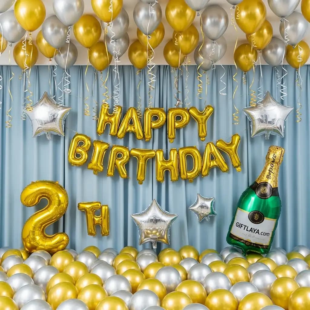 Glam second birthday setup with gold and silver balloons, floating stars, a giant inflatable champagne bottle golden balloon letters spelling “HAPPY BIRTHDAY 2th” against soft blue drapes